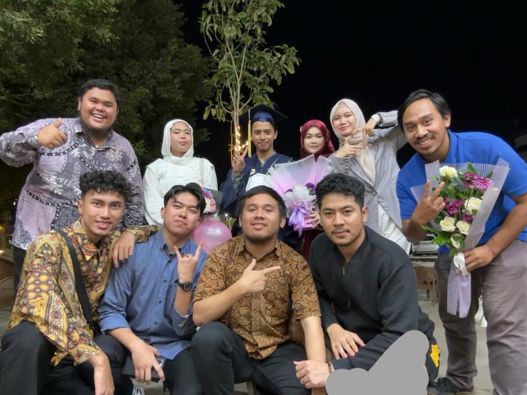 Ahmad Fathallah at his graduation ceremony with MMG friends
